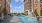 Resort-inspired saltwater pool with gas grilling station, outdoor shower, festival lighting and cabanas